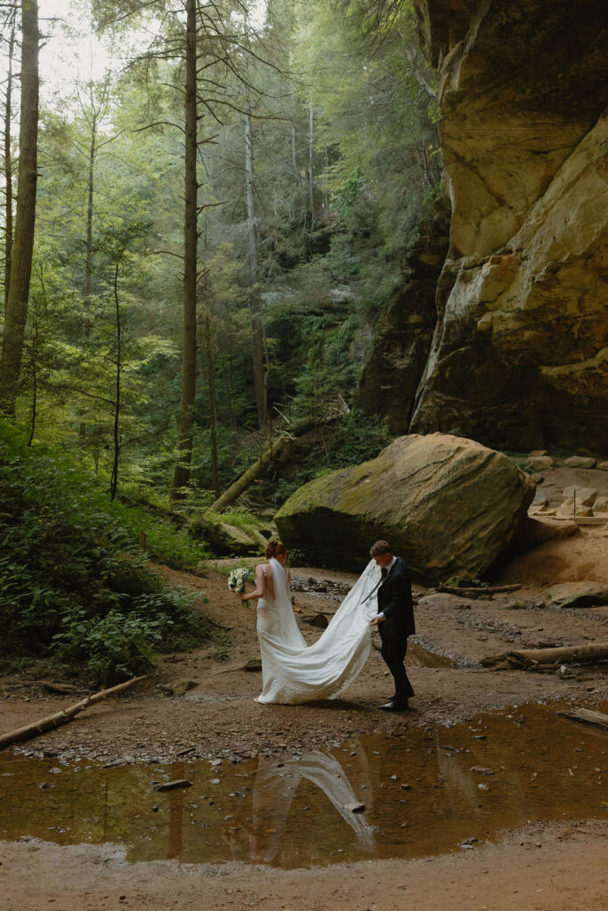Man carrying brides dress through Hocking Hills