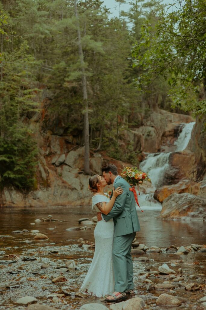 Bride and groom eloping at a waterfall for their elopement
