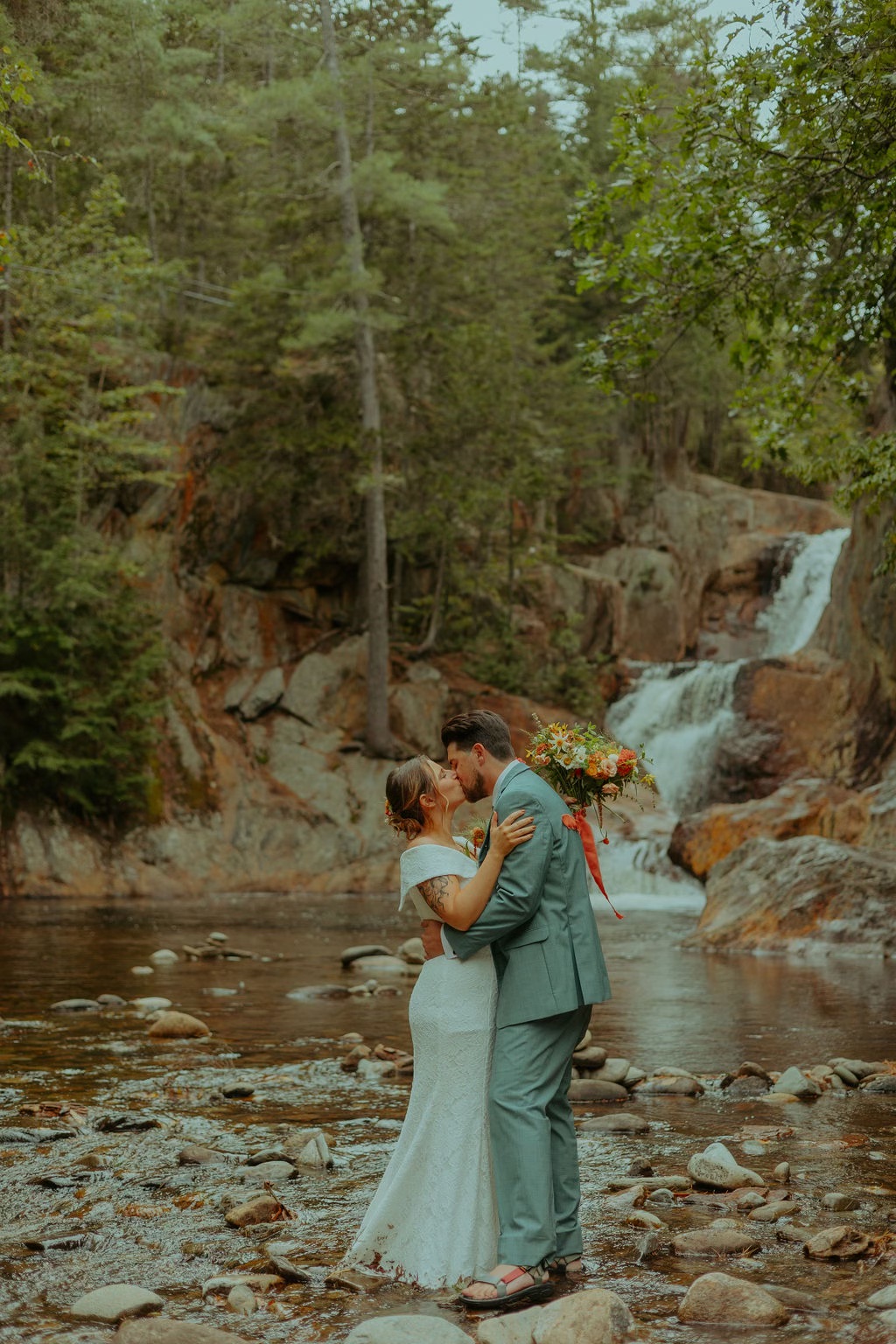 Bride and groom at waterfall destination elopement