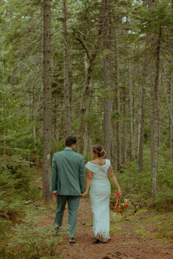 couple hiking during their maine elopement