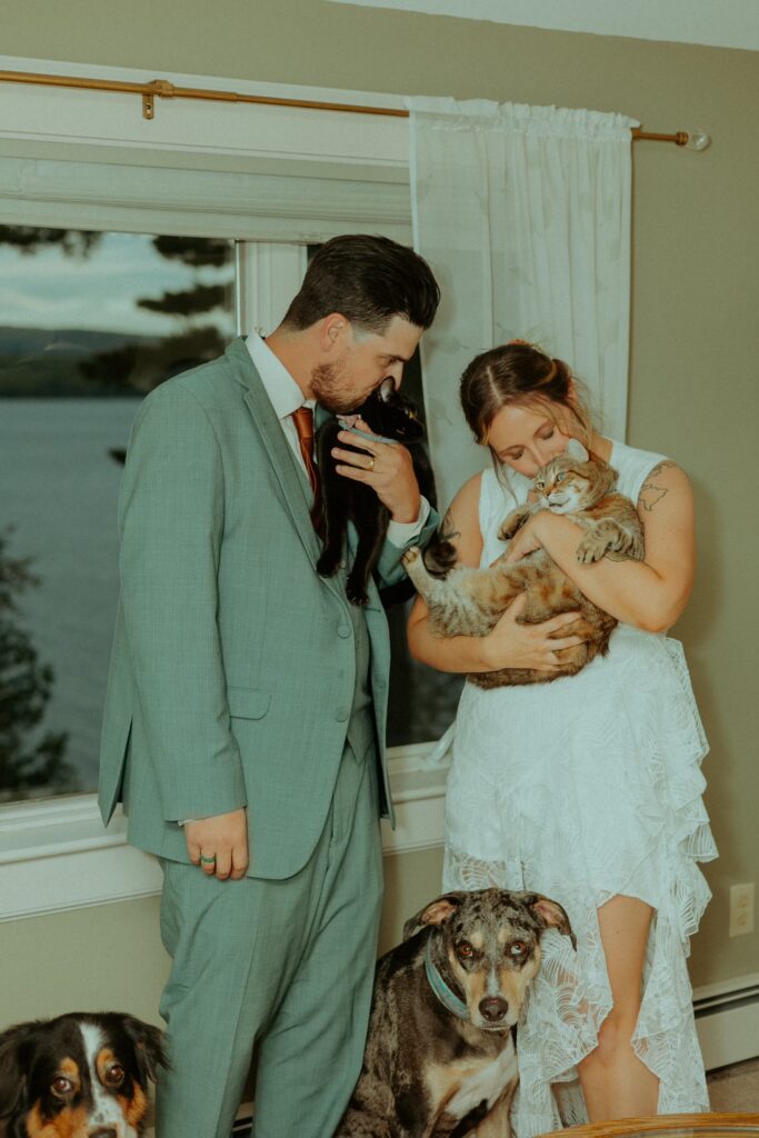 bride and groom cuddling their cats after their maine elopement