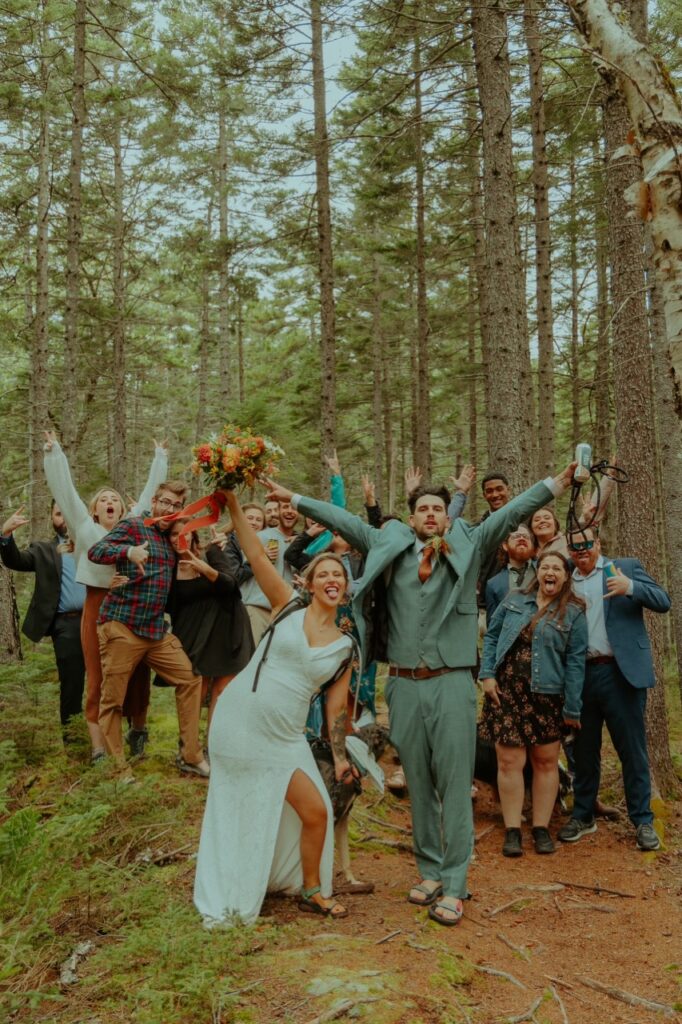 elopement couple pose with friends on a hike