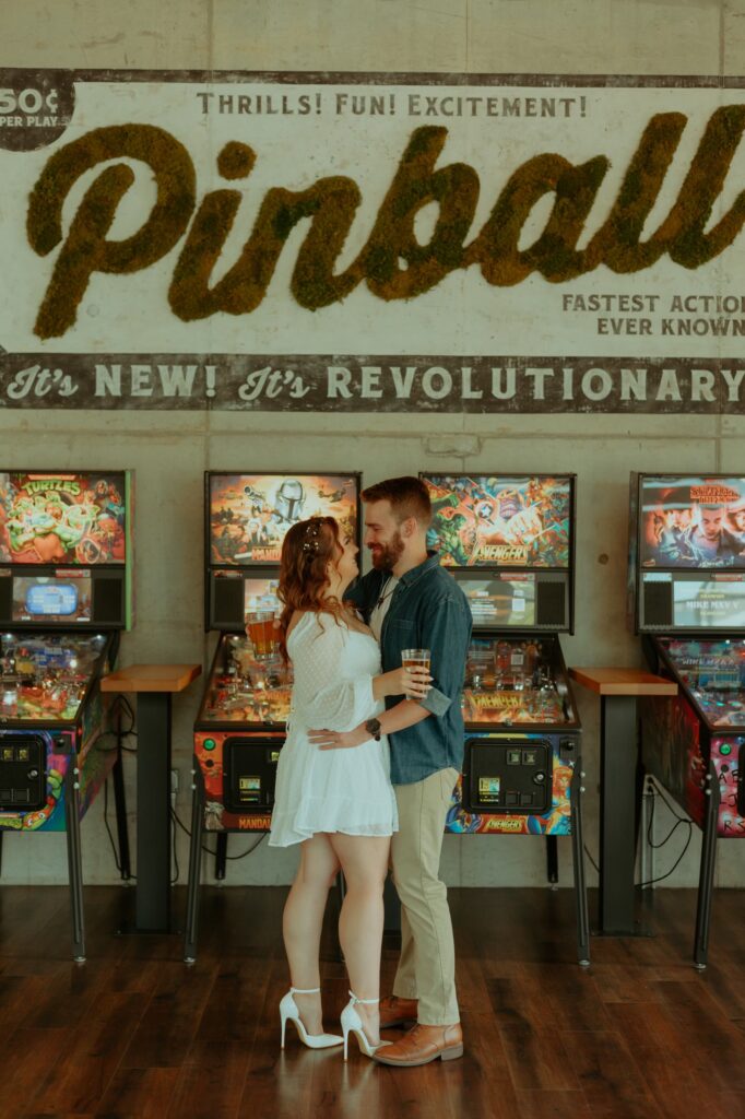Couple having a date night in a barcade for their Columbus Ohio engagement session 