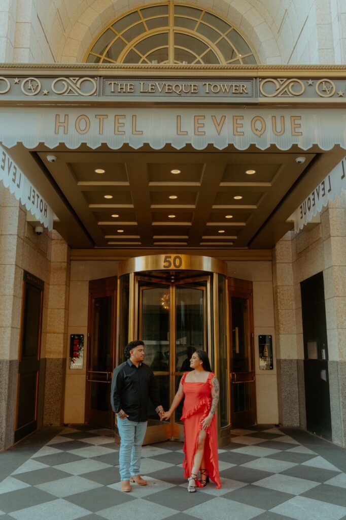 Man and woman posed outside of the Leveque tower in Columbus Ohio