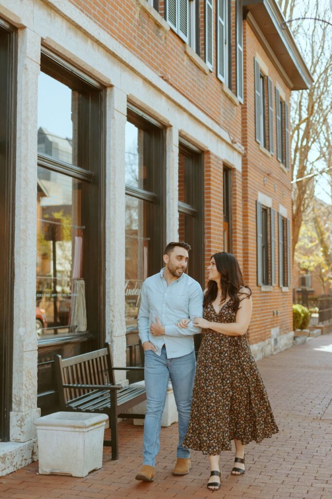 Couple walking down german village for their engagement session