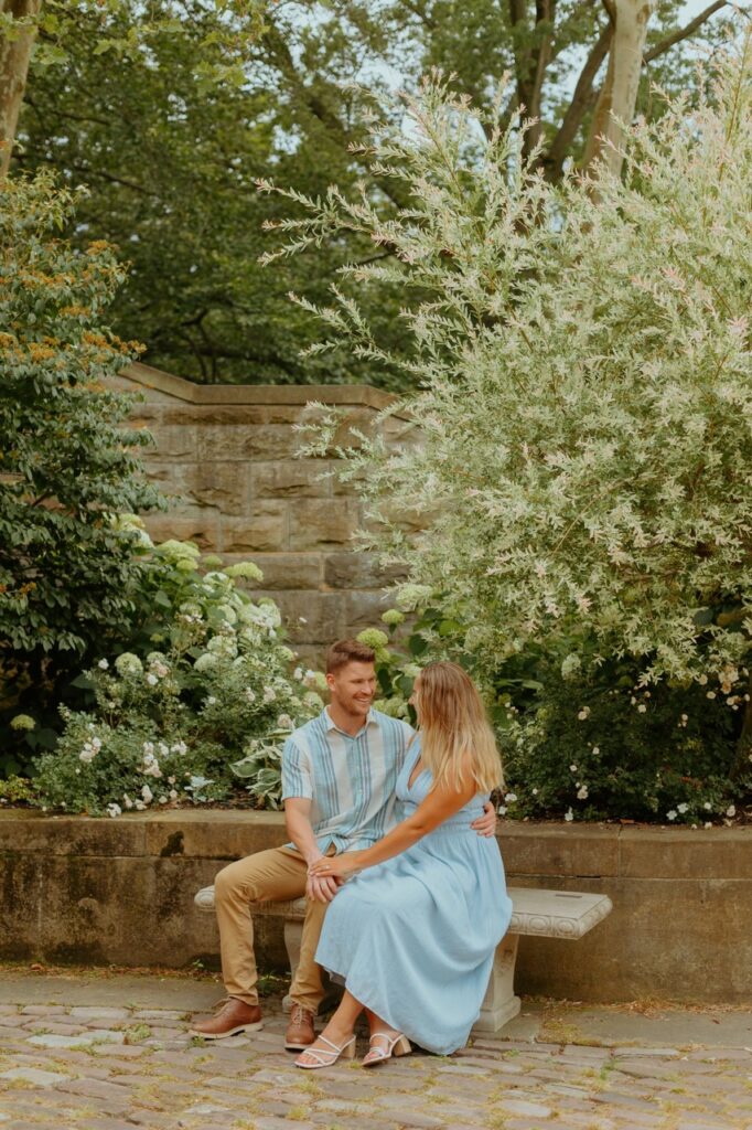 couple sitting during their Cleveland engagement session at the Italian Cultural Gardens