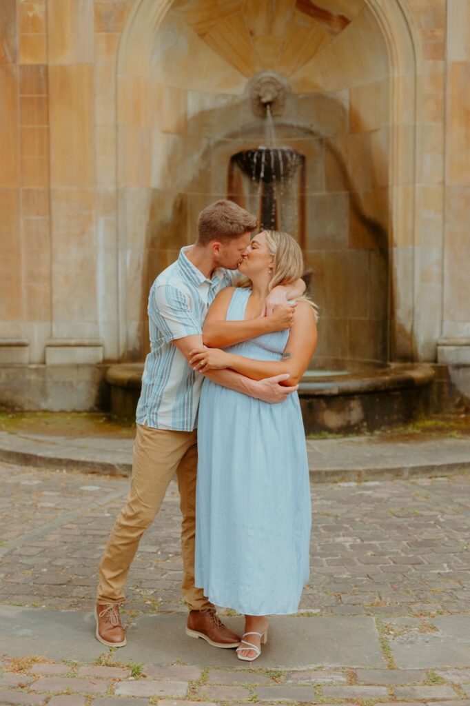 Boy holding woman for a kiss during their engagement session in Cleveland