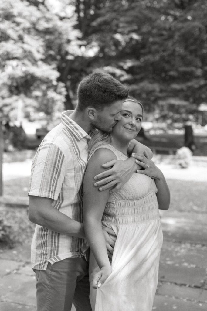 man kissing woman's cheek during their Cleveland engagement session