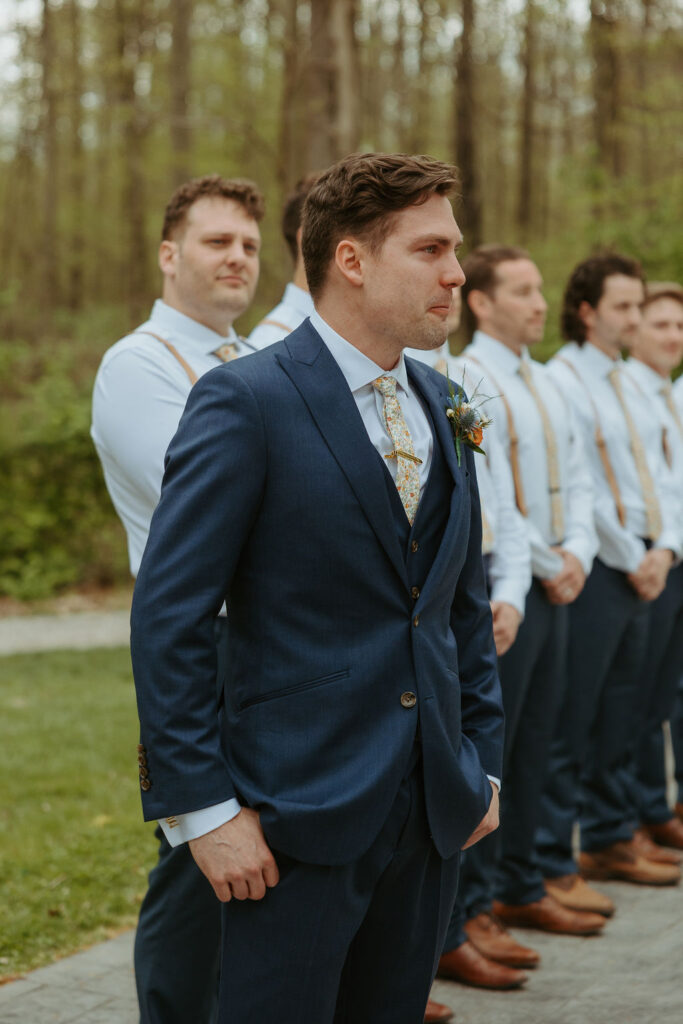 Man watching his bride come down the isle at their wedding