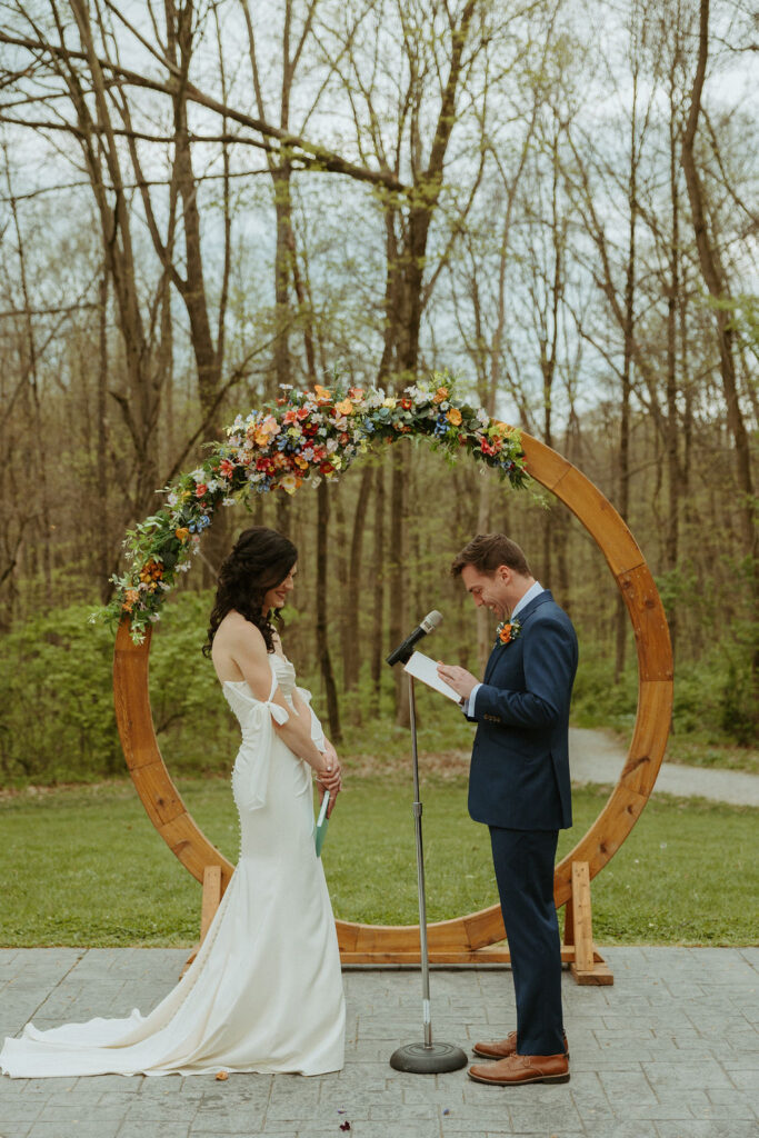 Groom reading his vows to his bride during their ceremony at The Brook