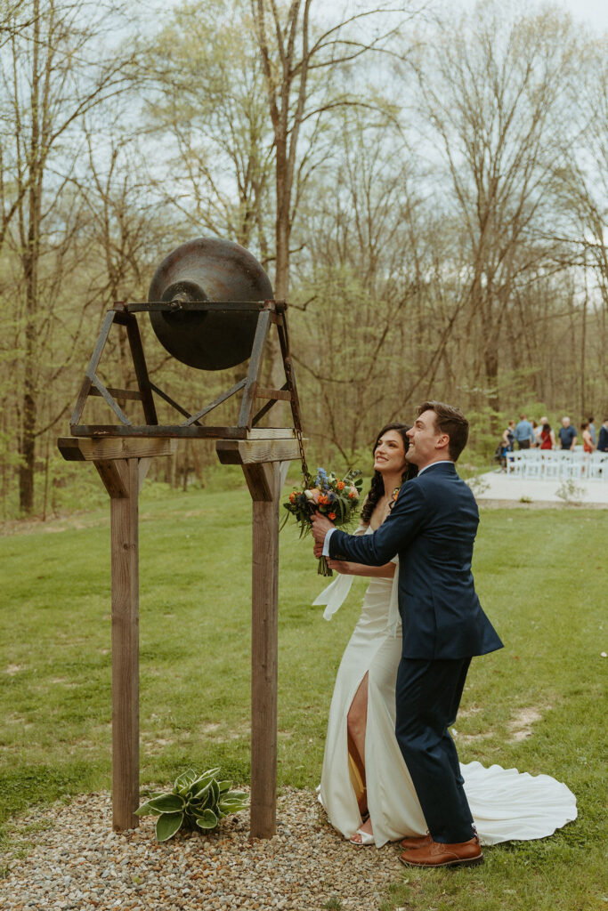 Groom and Bride ringing a bell at their wedding
