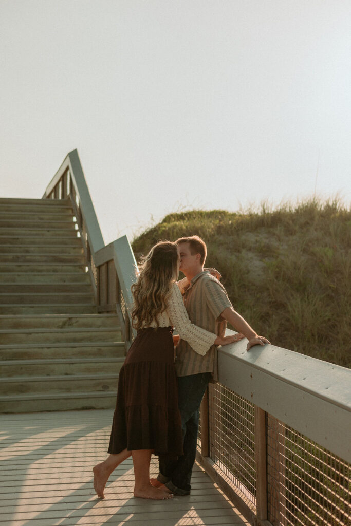 woman leaning towards man on a pier at St Augustine beach