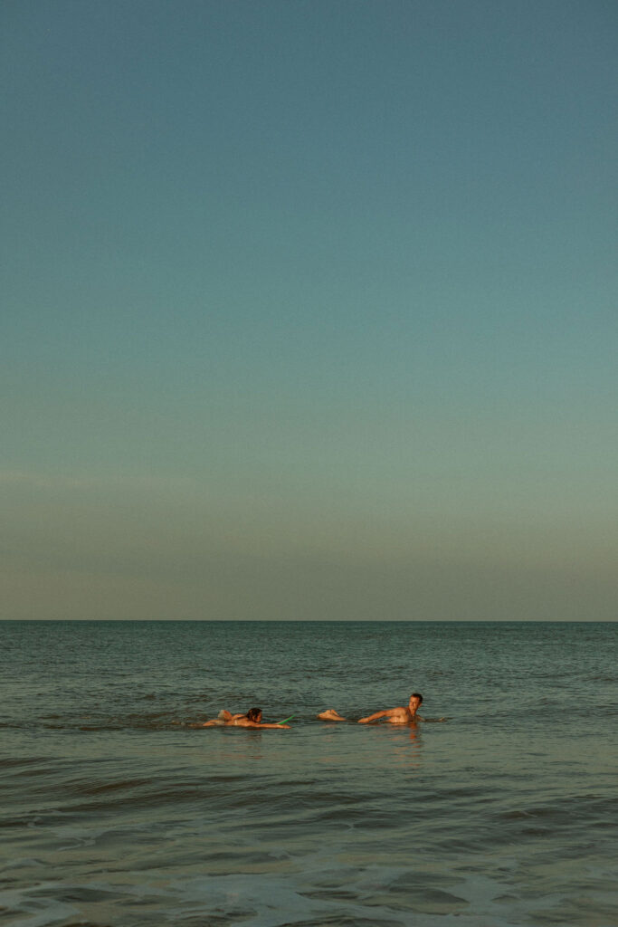 a couple swimming it the ocean