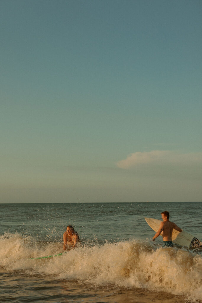 couple surfing waves at St Augustine beach