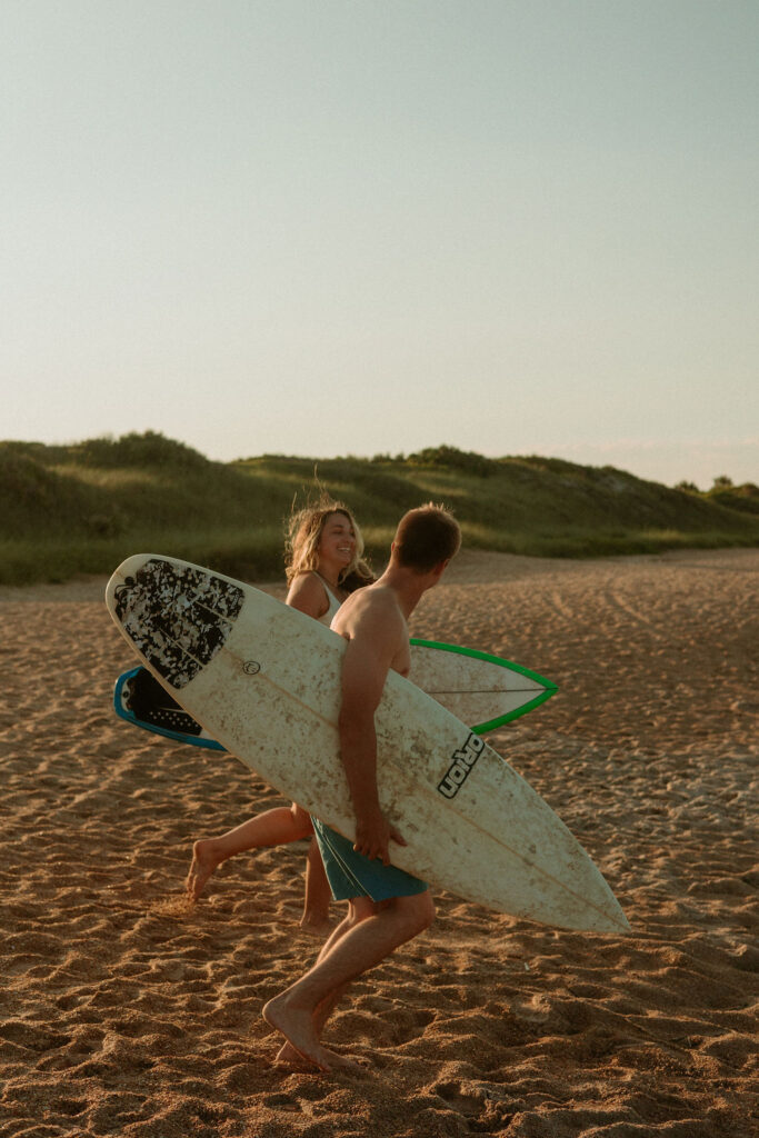 couple running towards the water at St Augustine Beach 