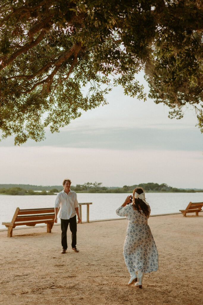 girl taking a video of her man at the Washington oaks gardens beach 