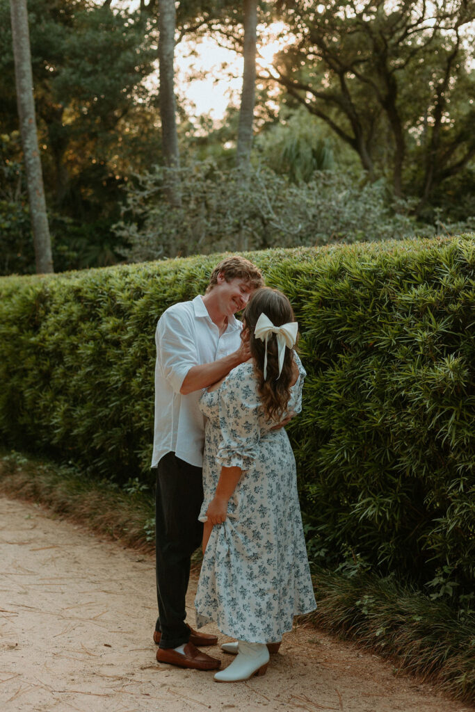 man holding woman's cheek in Washington oaks gardens