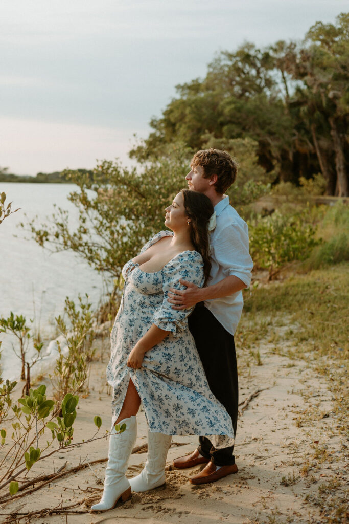 woman standing with her head resting on a mans chest 