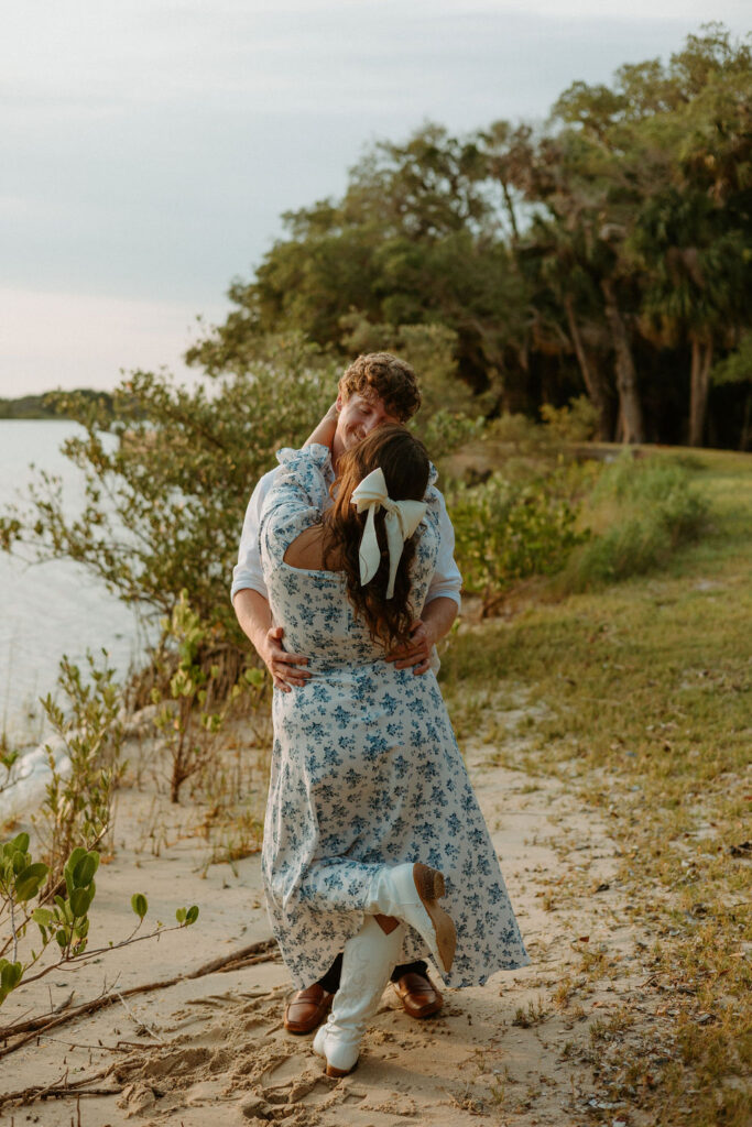 woman wrapping arms around man by the washington oaks gardens beach