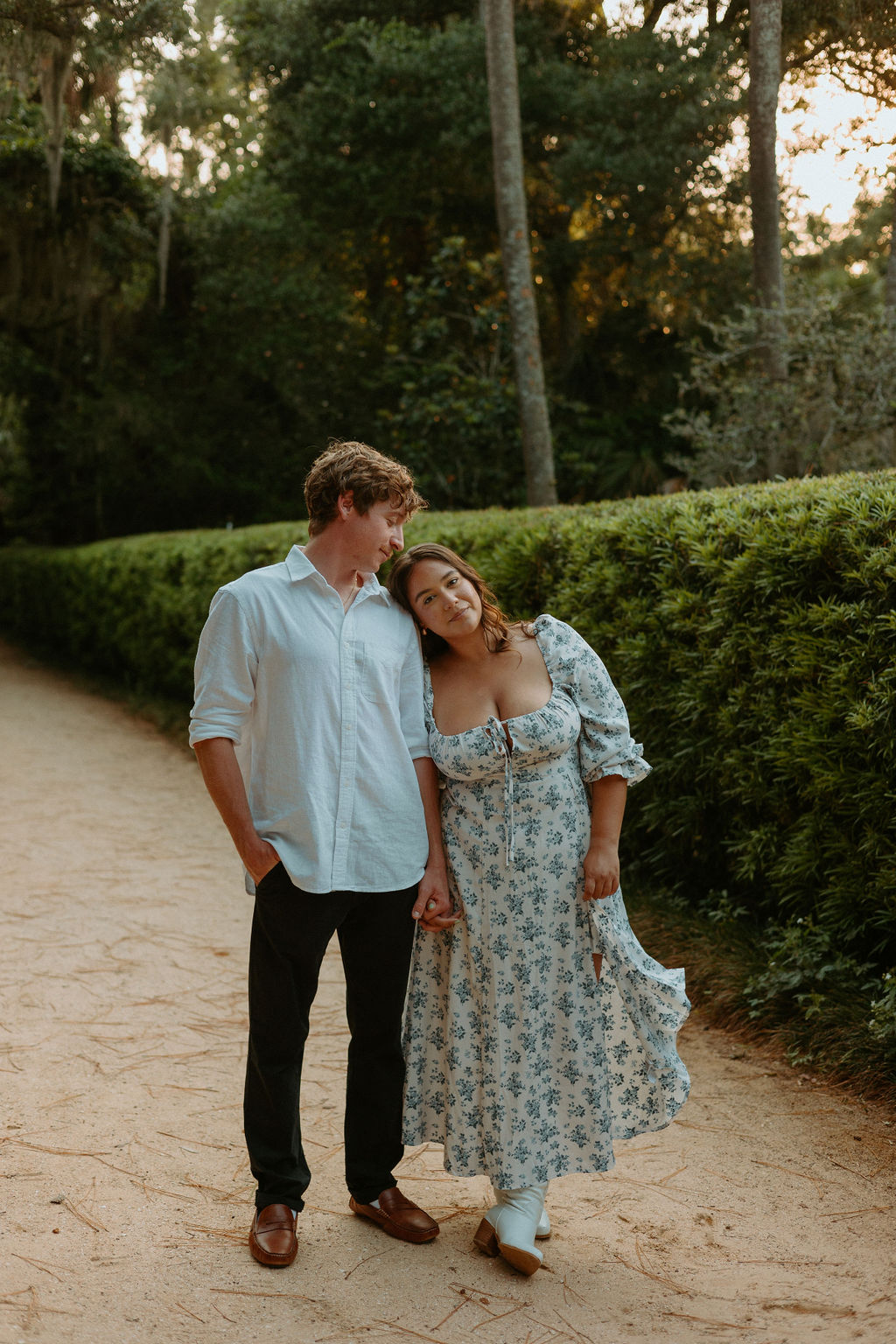 woman standing with her head leaning on a mans shoulder