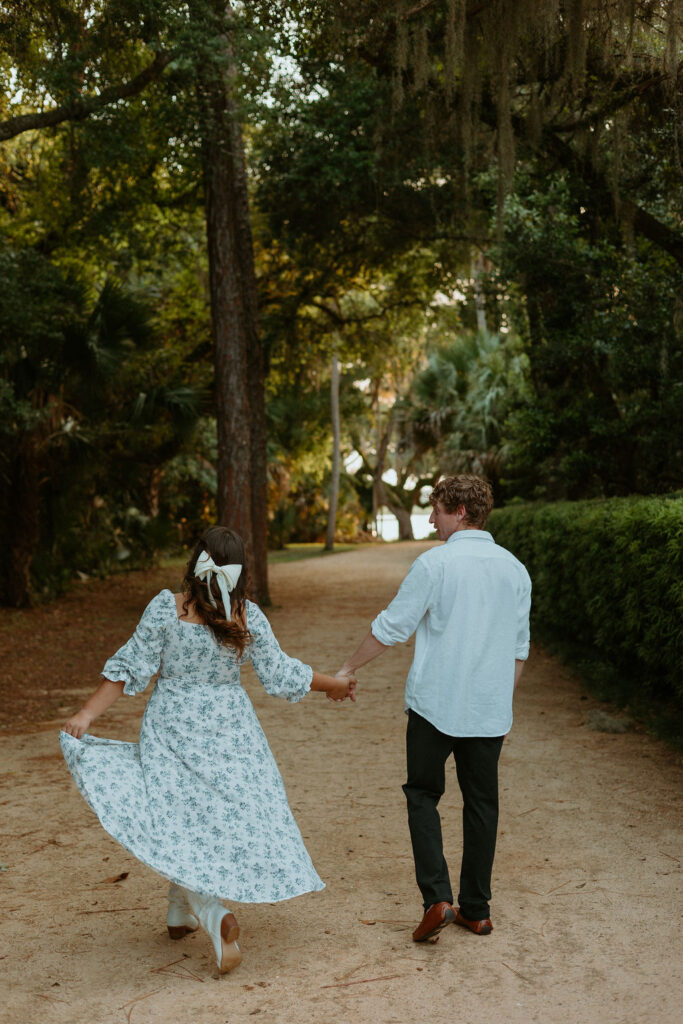 couple walking hand in hand during their Washington oaks gardens photos