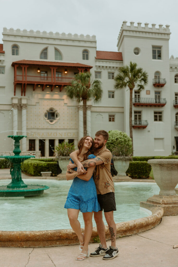 man wrapping his arms around a woman