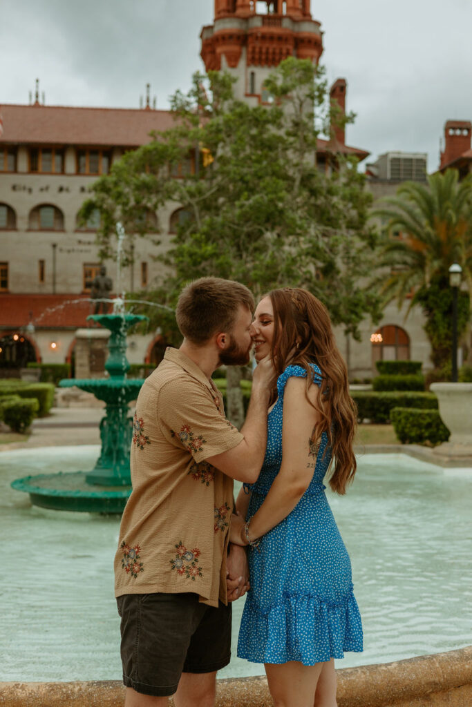 couple kissing by the water