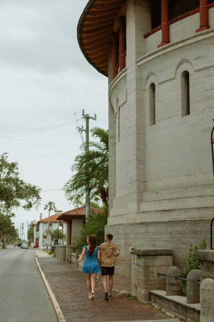 couple running through the streets in downtown St Augustine