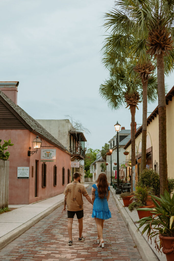 couple walking down the street holding hands