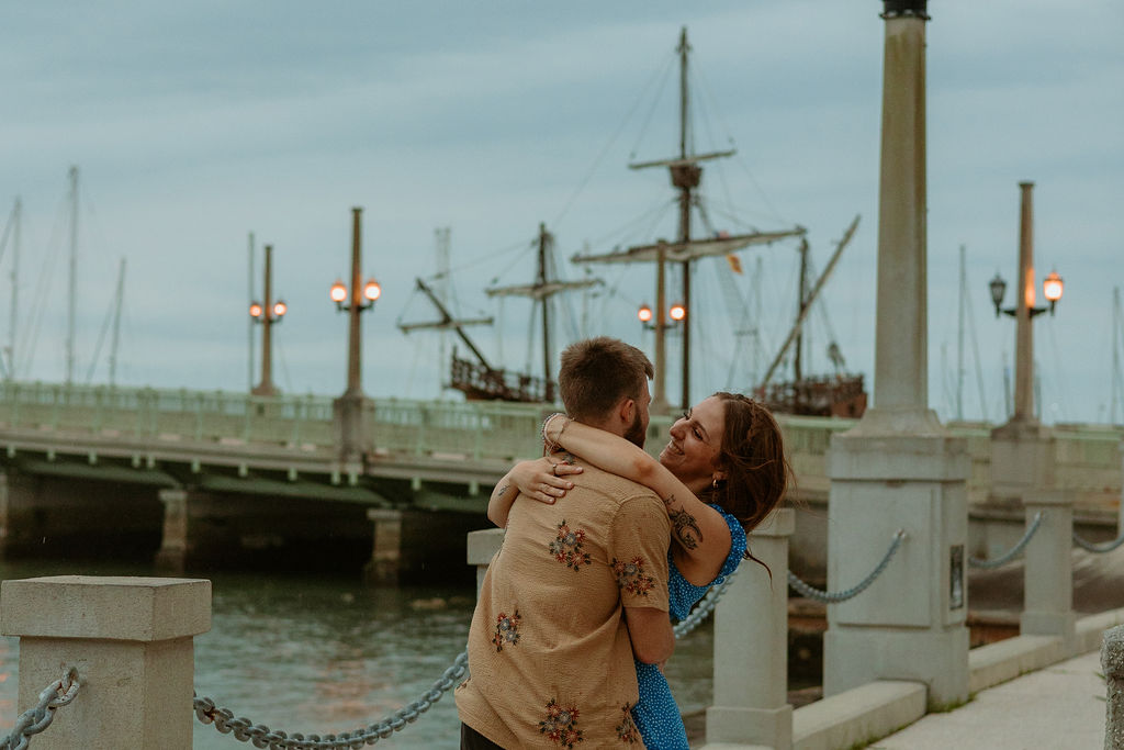 woman wrapping arms around mans neck