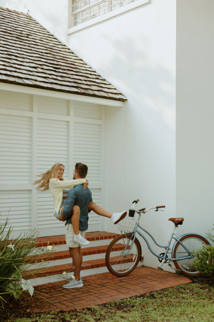 man carrying woman during their St Augustine bike photos 