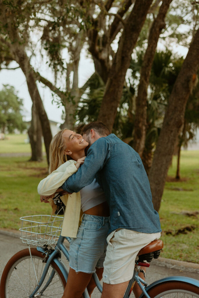 man hugging woman on a bike 