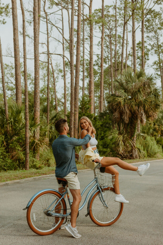 man caressing woman's cheek while she's sitting on a bike in St Augustine