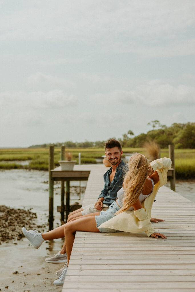 couple sitting on a pier at their St Augustine home