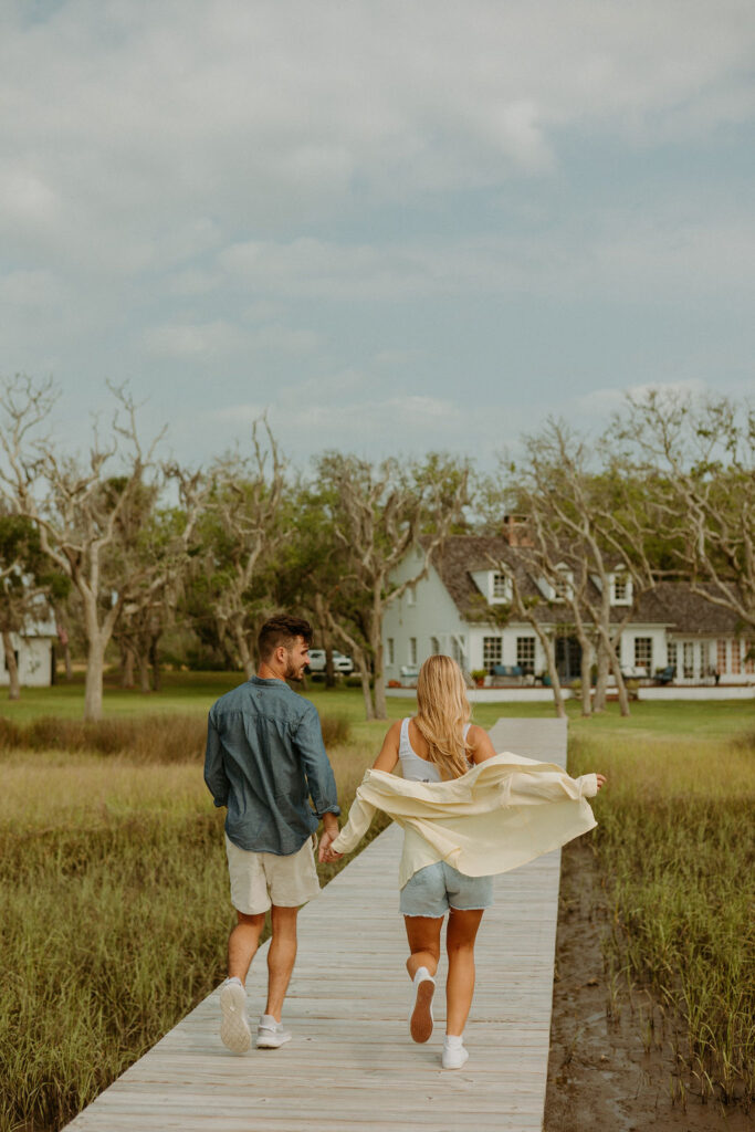 man and woman walking along the pier 