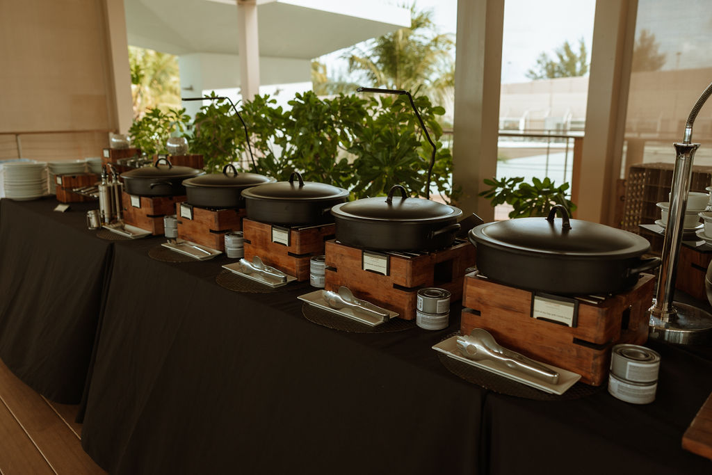 a line of buffet food sitting on a table