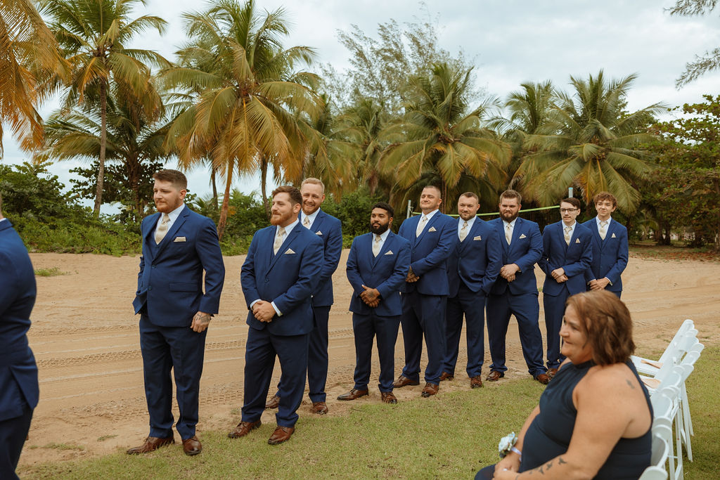 outdoor puerto rico wedding ceremony with groomsmen in blue suits