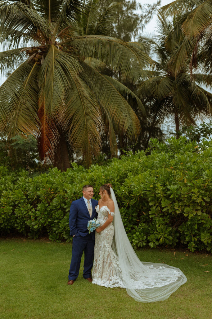 formal portraits of puerto rico wedding couple outside by palm trees