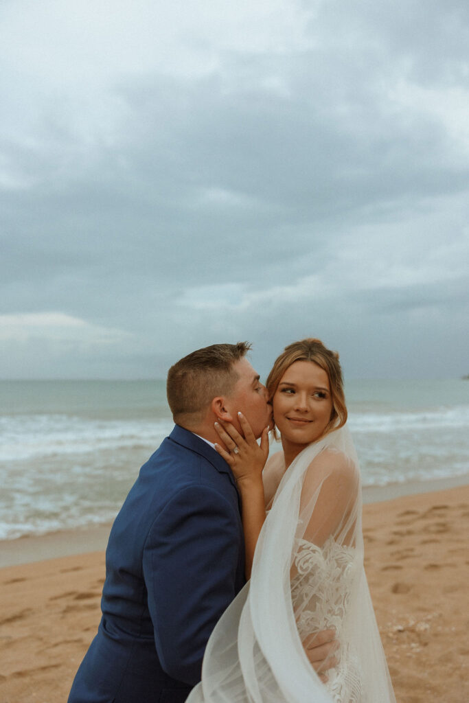 groom kissing brides cheek