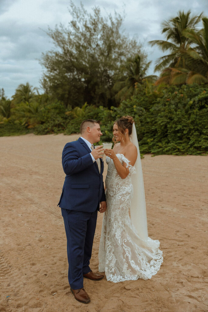 bride and groom having a drink on the beach 