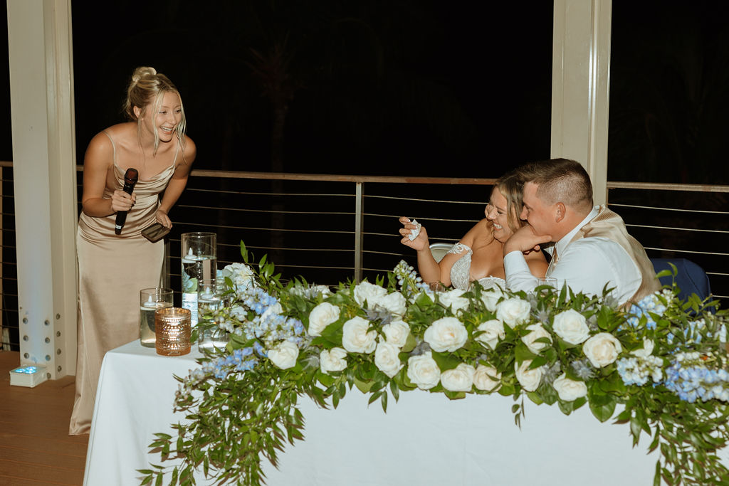 maid of honor giving a speech while people laugh