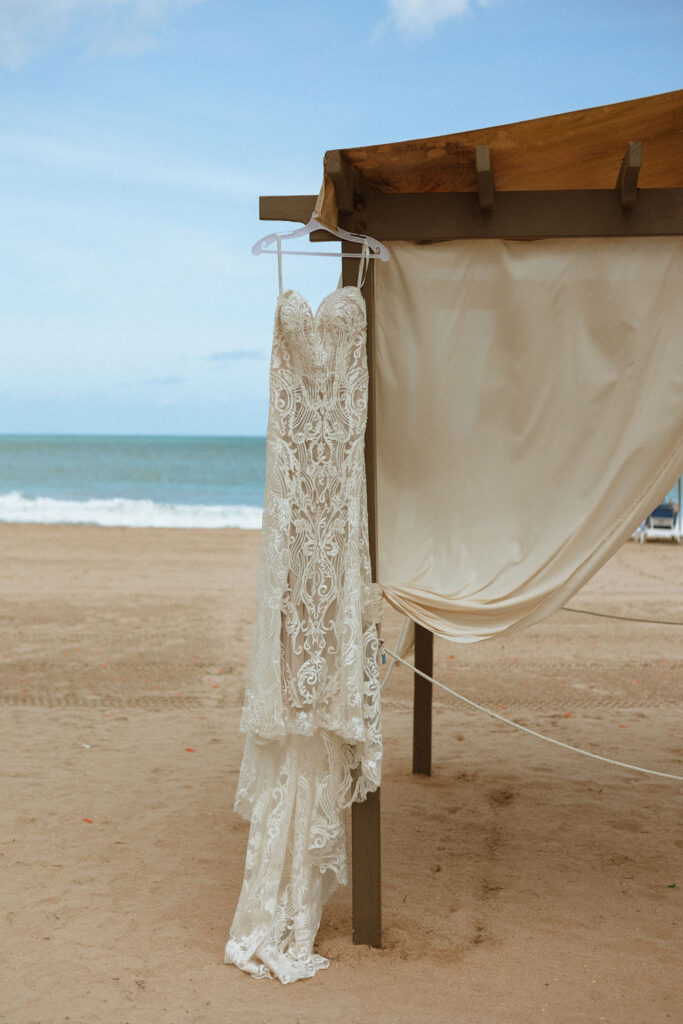 a puerto rico wedding dress hanging on the beach