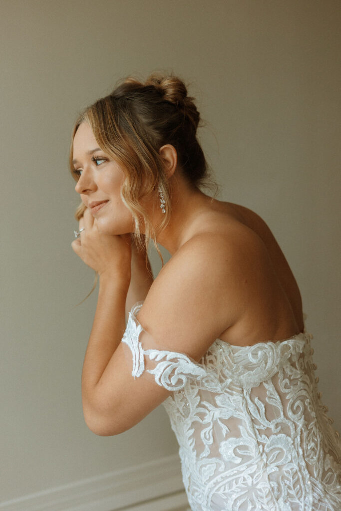 bride putting jewelry on