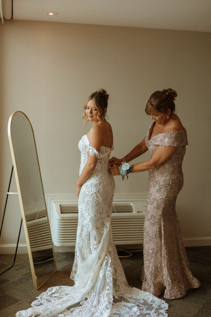 mom zipping up brides dress for her puerto rico wedding