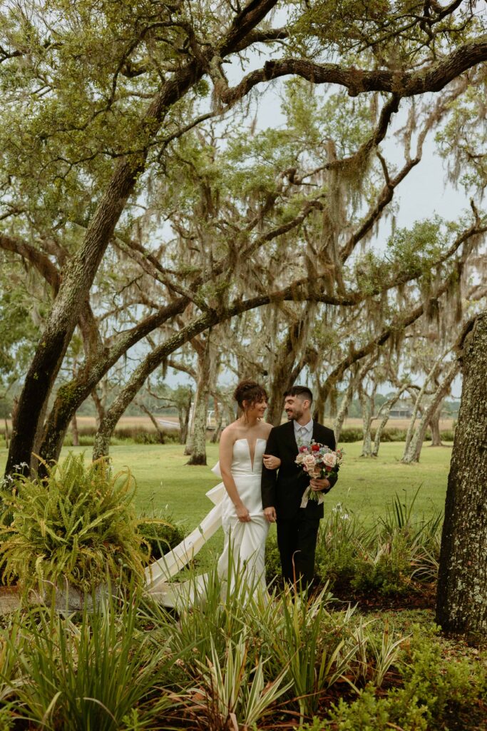 couple walking along a path of greenery