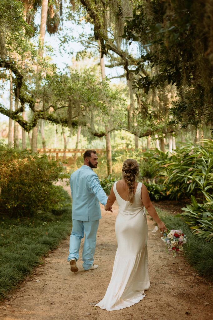 bride and groom walking a path to elope in Florida