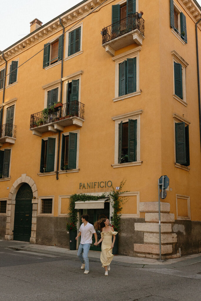 Couple laughing while walking through Verona's Piazza