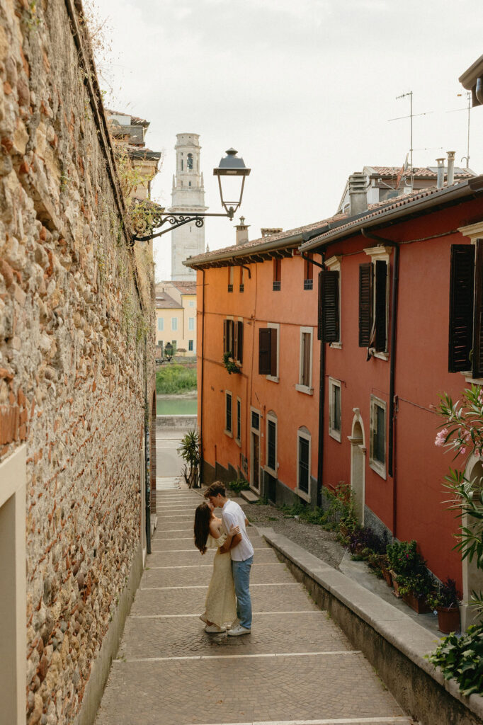 Couple exploring hidden corners of Verona during romantic engagement session