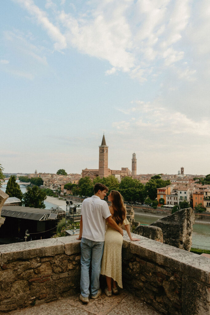 Couple looking over the Verona river in their engagement session