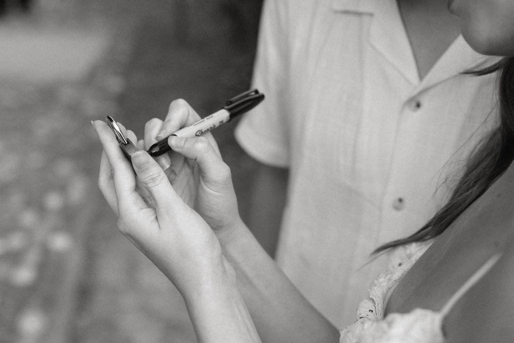Woman writing on a heart locket in Verona 